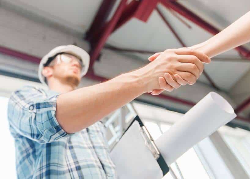 a construction worker shaking hands with someone