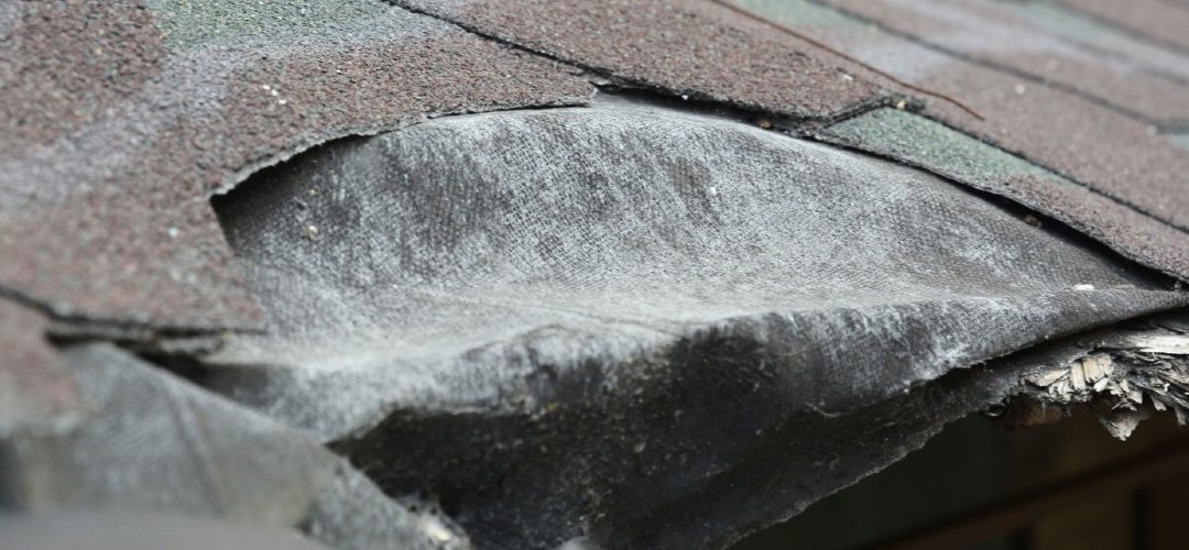 shingles on a roof that have fallen apart